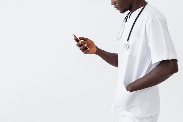 Specialist male doctor using his mobile phone