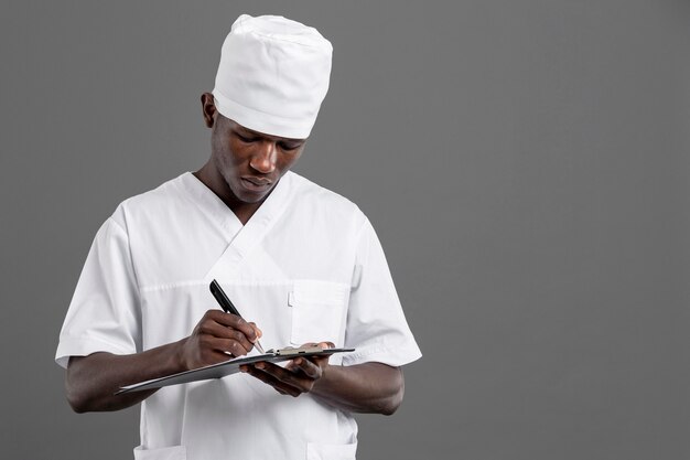 specialist male doctor writing his notes
