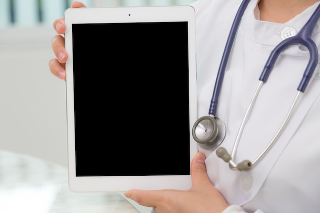 Specialist with stethoscope holding a tablet