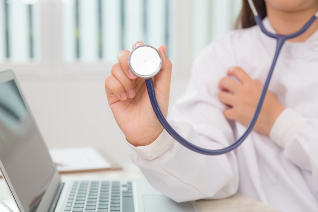 Specialist with stethoscope and laptop