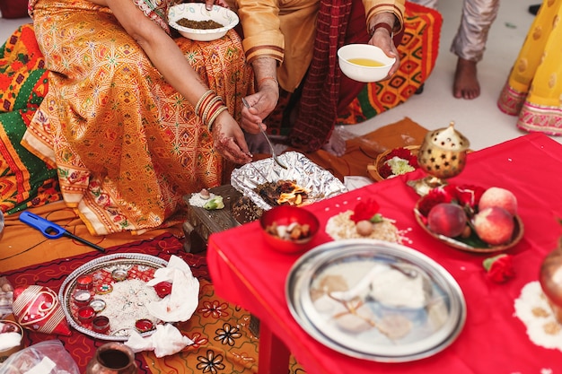 Species and fruits surround Indian parents preparing paste