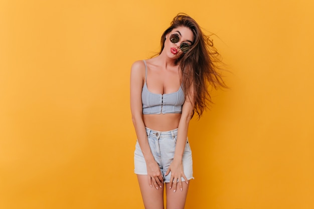 Spectacular girl in summer attire wearing black sunglasses