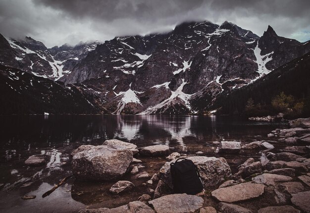 Spectacular view to the beautiful mountains with mirroed reflection and clouds at sunrise time.