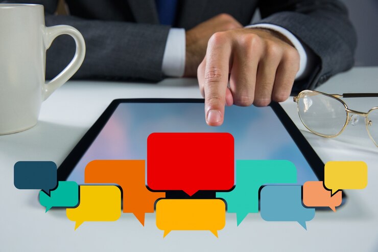 Free Photo speech bubbles with businessman working on his tablet