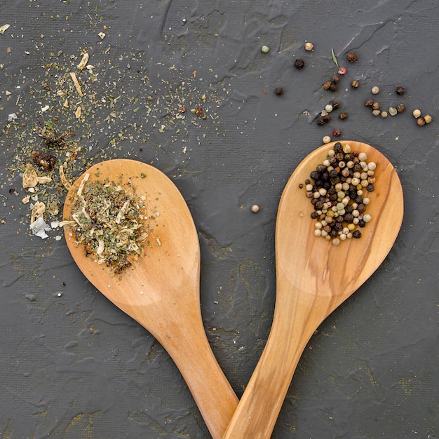 Spices and herbs on wooden spoon top view
