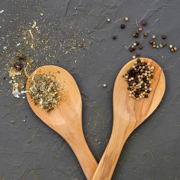 Spices and herbs on wooden spoon top view