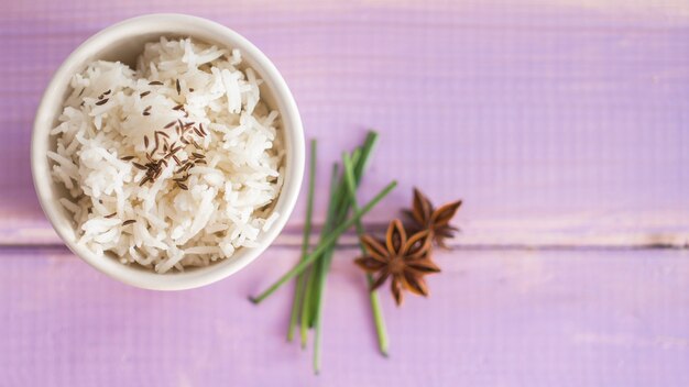 Spices near bowl of rice