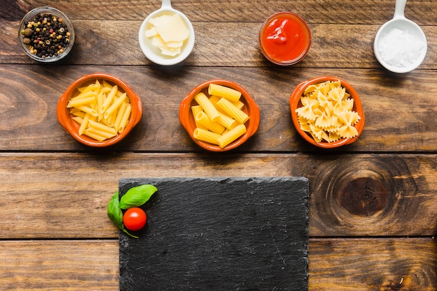 Spices and pasta near board