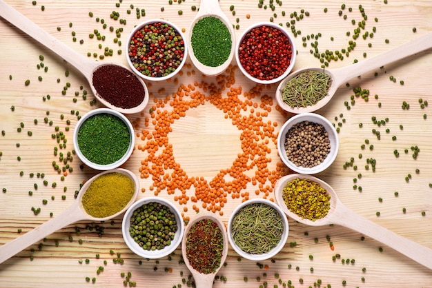 Free photo spices in spoons on wooden table