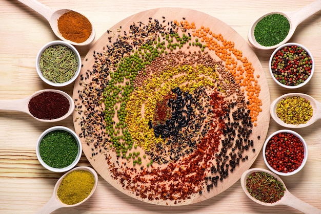 Spices on wooden board and in spoons