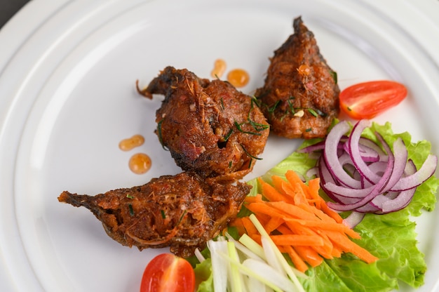 Spicy Fried Stir Catfish on white plate, Thai food.