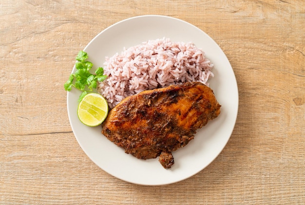Острый ямайский вяленый цыпленок на гриле с рисом - ямайский стиль еды Premium Фотографии