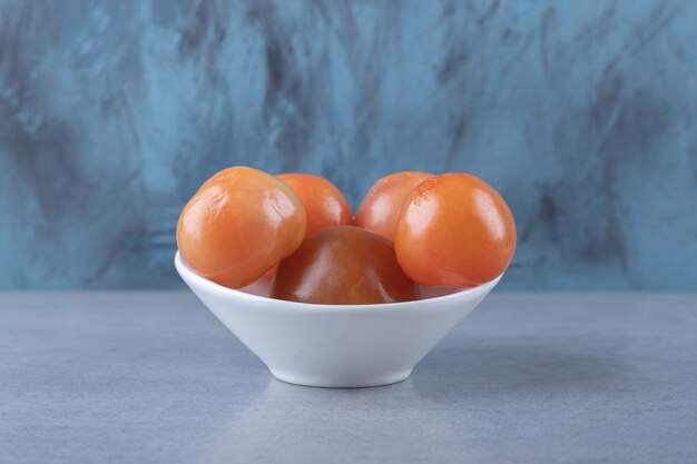 Spicy marinated tomatoes in bowl