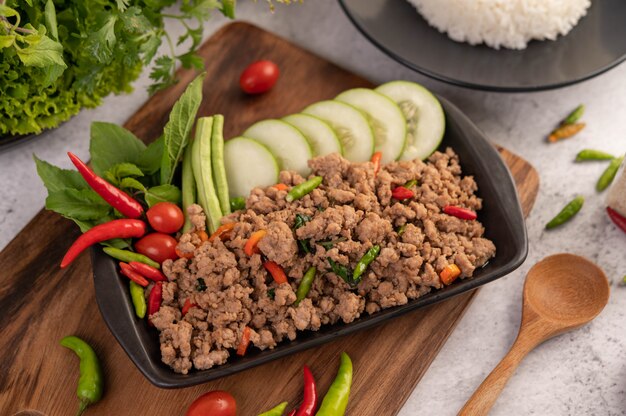 Spicy minced pork and rice on a black plate.