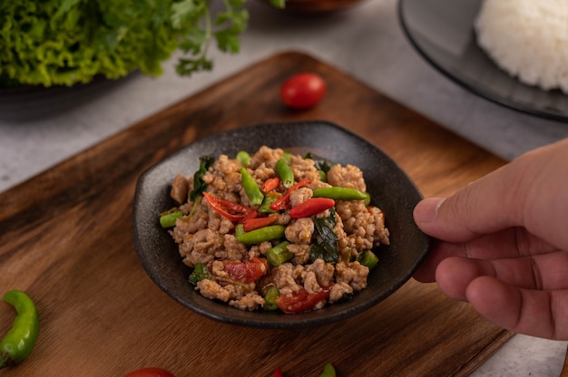 Free photo spicy minced pork and rice on a black plate.