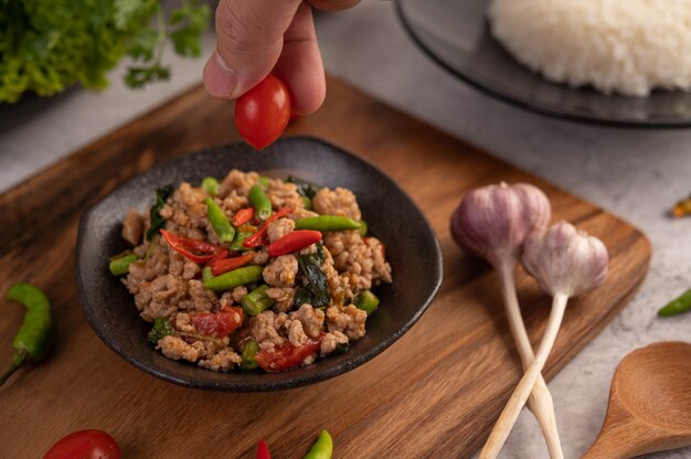 Spicy minced pork and rice on a black plate.