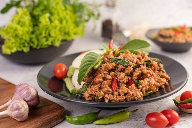 Spicy minced pork and rice on a black plate.