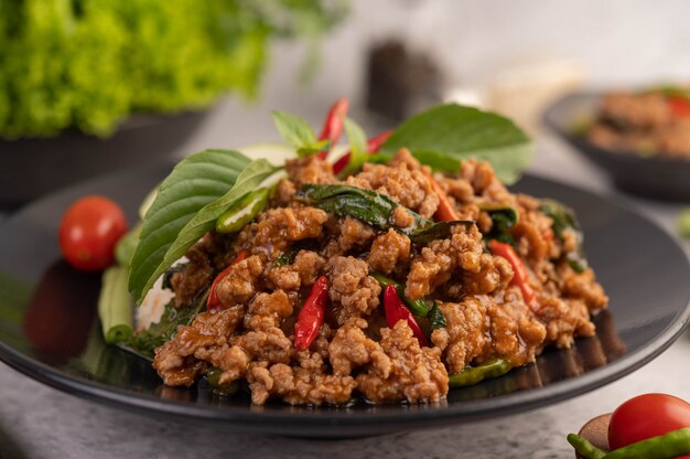 Spicy minced pork and rice on a black plate.