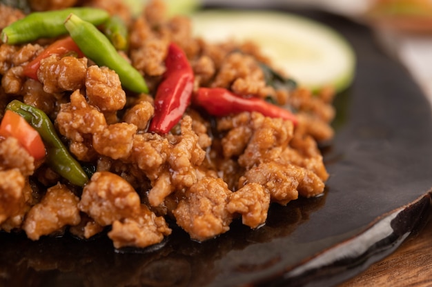 Spicy minced pork and rice on a black plate.