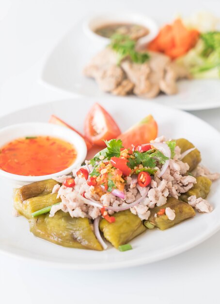 Spicy minced pork salad with flaming eggplant