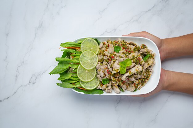 Spicy Pork Salad Served with fresh crispy kale stalks Thai food.