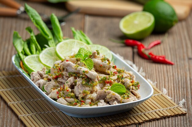 Spicy Pork Salad Served with fresh crispy kale stalks Thai food.