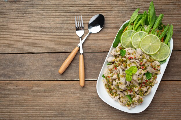 Spicy Pork Salad Served with fresh crispy kale stalks Thai food.