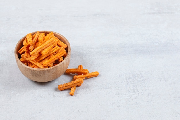 Spicy stick chips in wooden bowl.