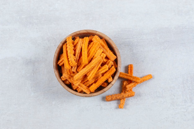 Spicy stick chips in wooden bowl.
