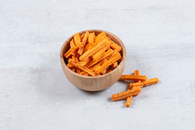 Spicy stick chips in wooden bowl.