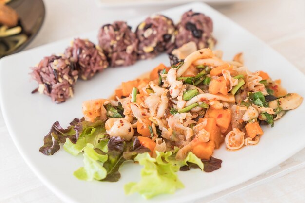 Spicy vegan salad with sticky berry and grain rice