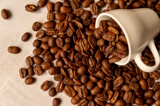 Spilled coffee cup with roasted beans