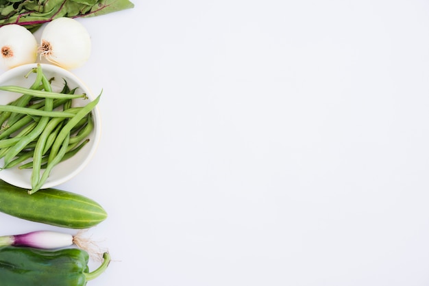 Spinach; onion; green beans; cucumber; bell pepper and scallion isolated on white background