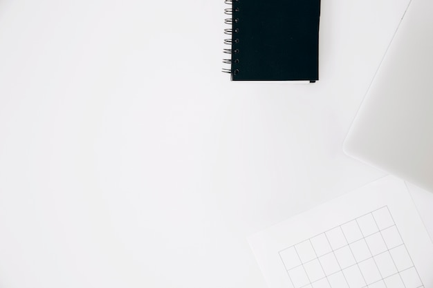 Spiral notepad; laptop and page isolated on white background