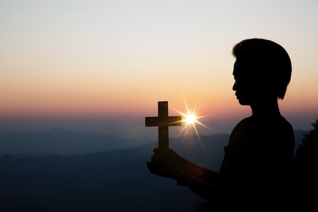 spiritual prayer hands over sun shine with blurred beautiful sunset 