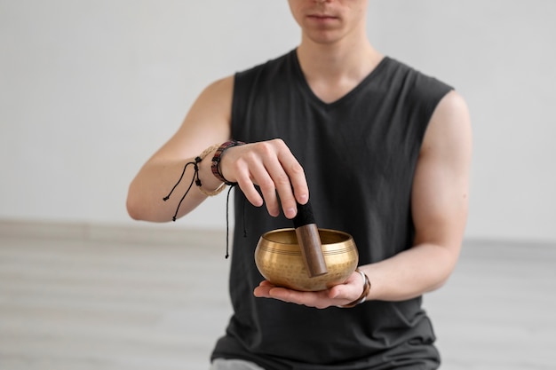 Spiritual young man practicing yoga indoors