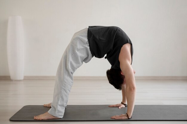 Spiritual young man practicing yoga in sportswear