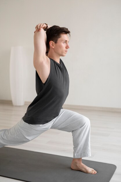 Spiritual young man practicing yoga in sportswear