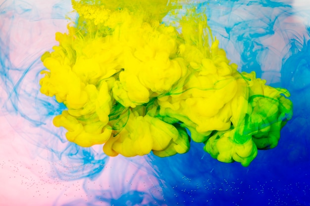 Free photo splashes of bright paint in water