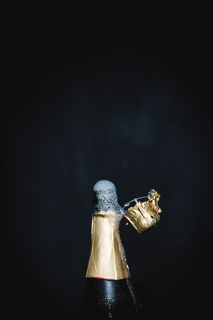 Free photo splashing bottle of champagne