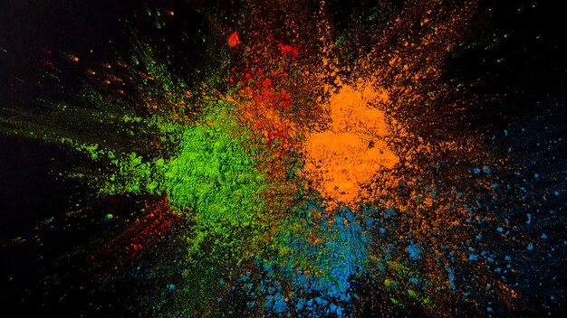 Splatted green,blue and orange color on black background