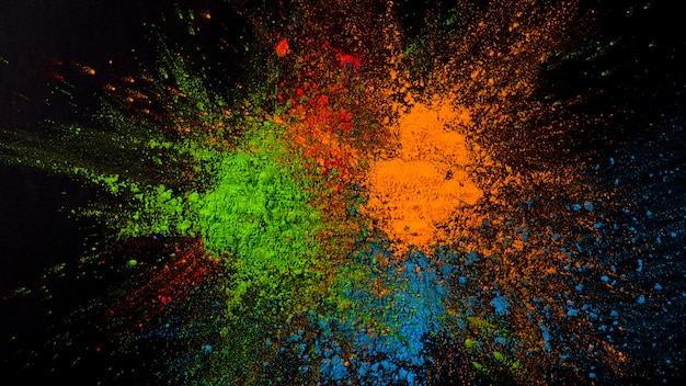 Splatted green,blue and orange color on black background