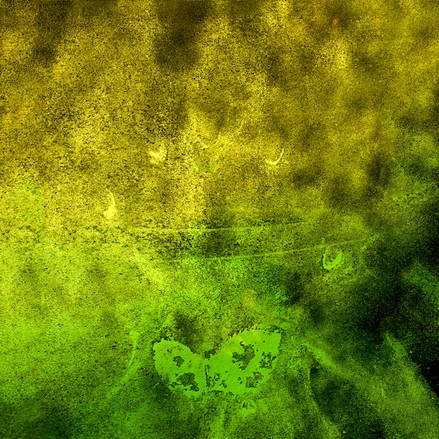 Splatted yellow and green holi powder