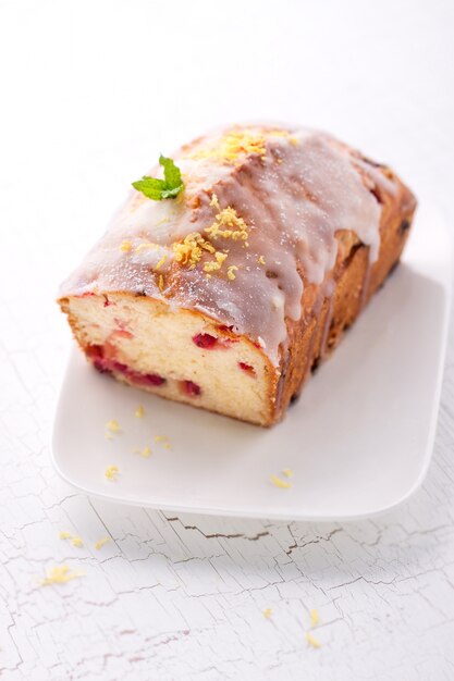 Sponge cake with red berries on a plate