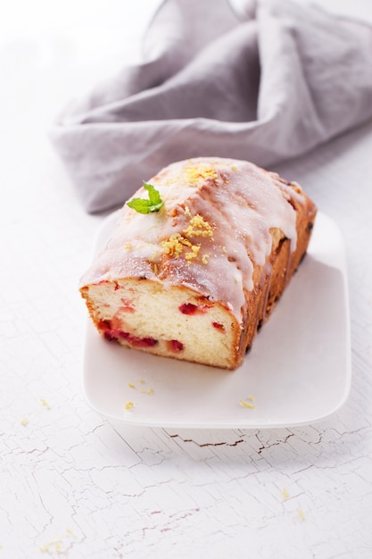 Sponge cake with red berries on a plate