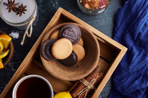 Sponge cookies with chocolate and a cup of tea. 