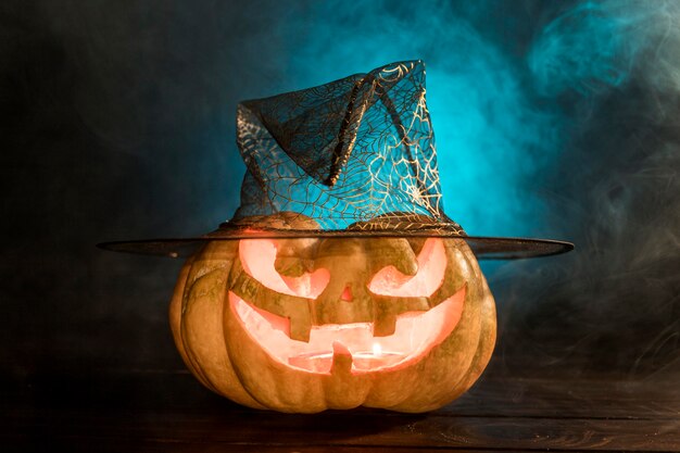 Spooky carved pumpkin with hat