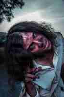 Free photo spooky female zombie outdoors