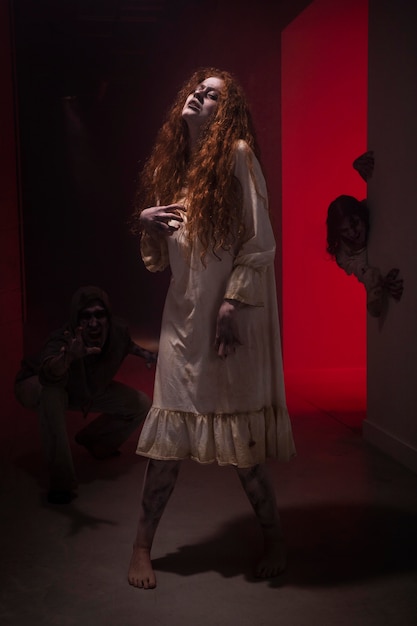 Spooky ginger female zombie in a dress