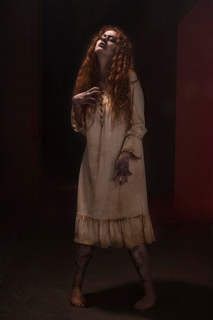 Spooky ginger female zombie in a dress
